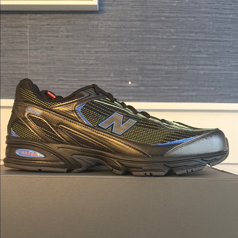 New Balance 509 Black Athletic Sneaker with Blue Accents